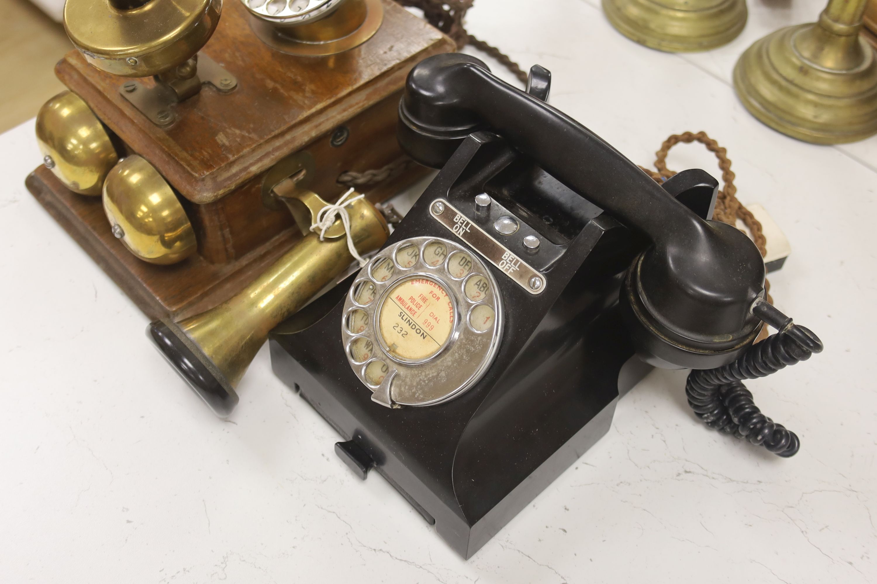 A 20th century black bakelite telephone, Slindon 232, the receiver marked 164-48, together with a further early timber cased telephone